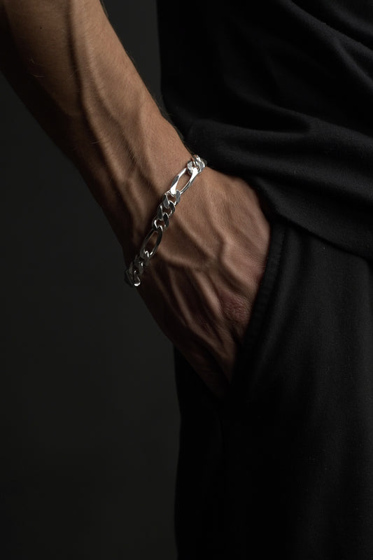 Silver chain bracelet on a dark fabric background