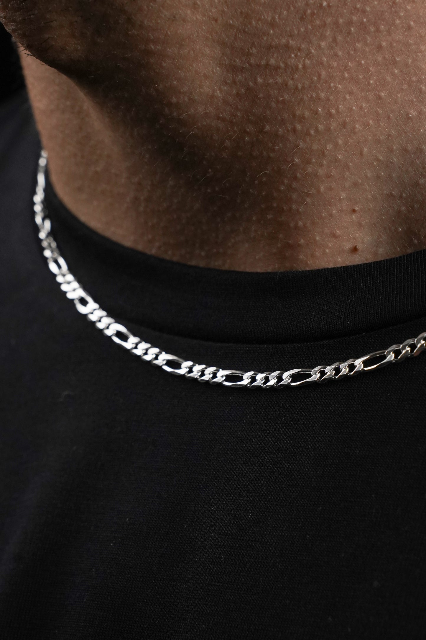 Silver chain necklace on a black shirt