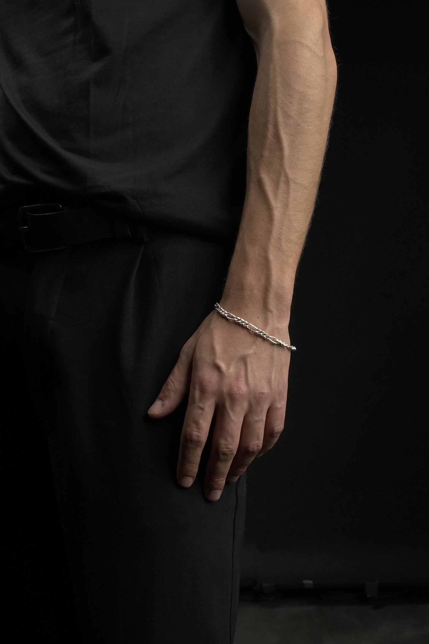 Hand with a bracelet on a dark background