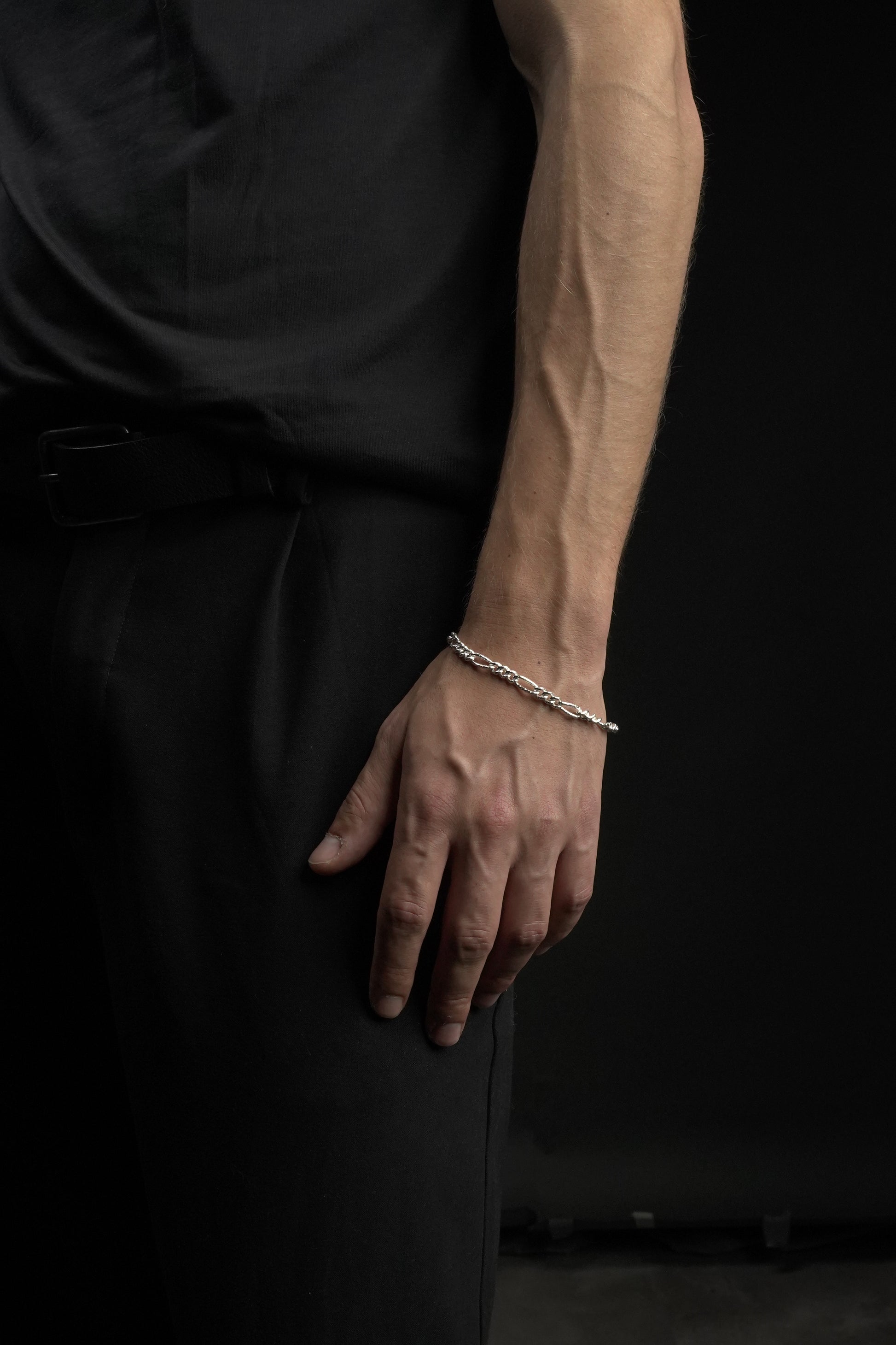 Hand with a bracelet on a dark background
